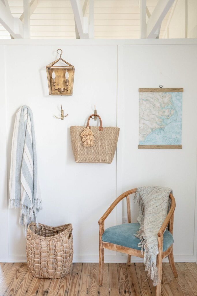 watercolor painting of a coastal map hanging on a wall with boho decor, basket, and chair in Wilmington, North Carolina