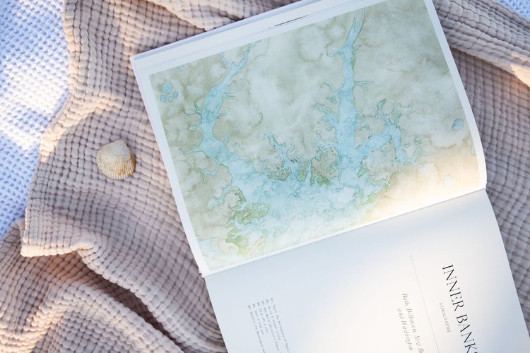 watercolor painting of a coastal map laying on a beach blanket in Wilmington, North Carolina