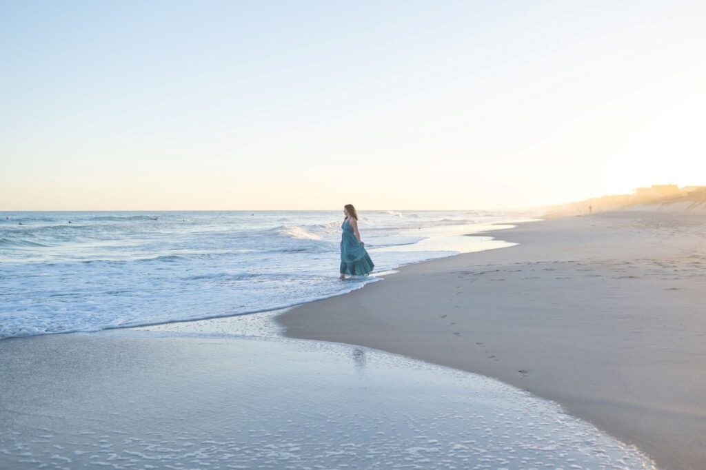 Meet Laura, a local watercolor artist standing on a beach in Wilmington, North Carolina