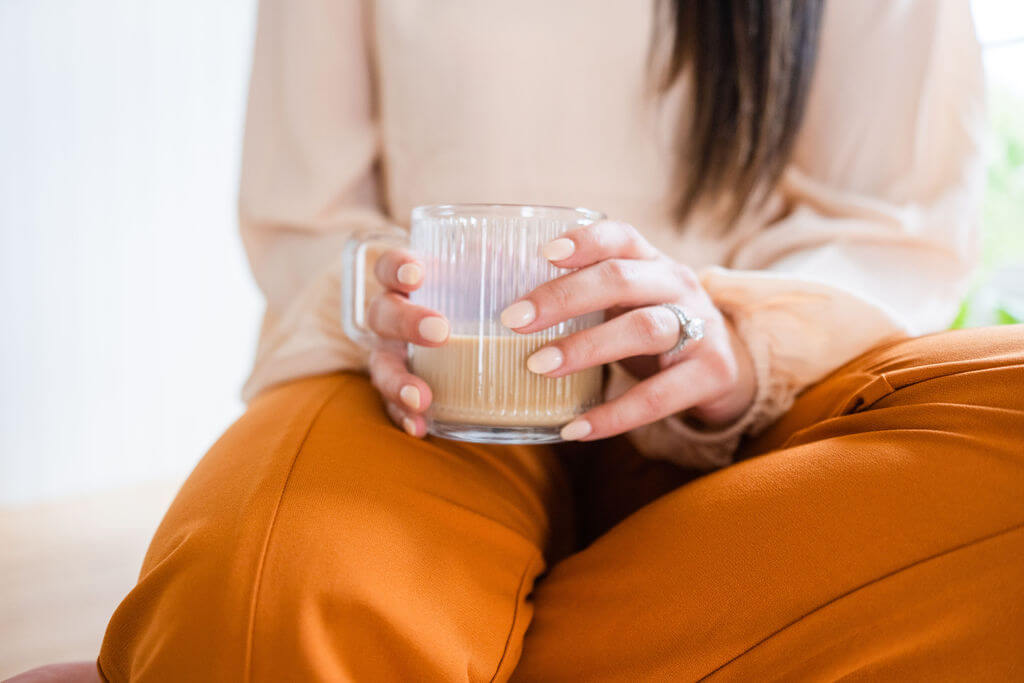 Real Estate Agent holds a coffee mug for her branding photography session in Wilmington North Carolina.