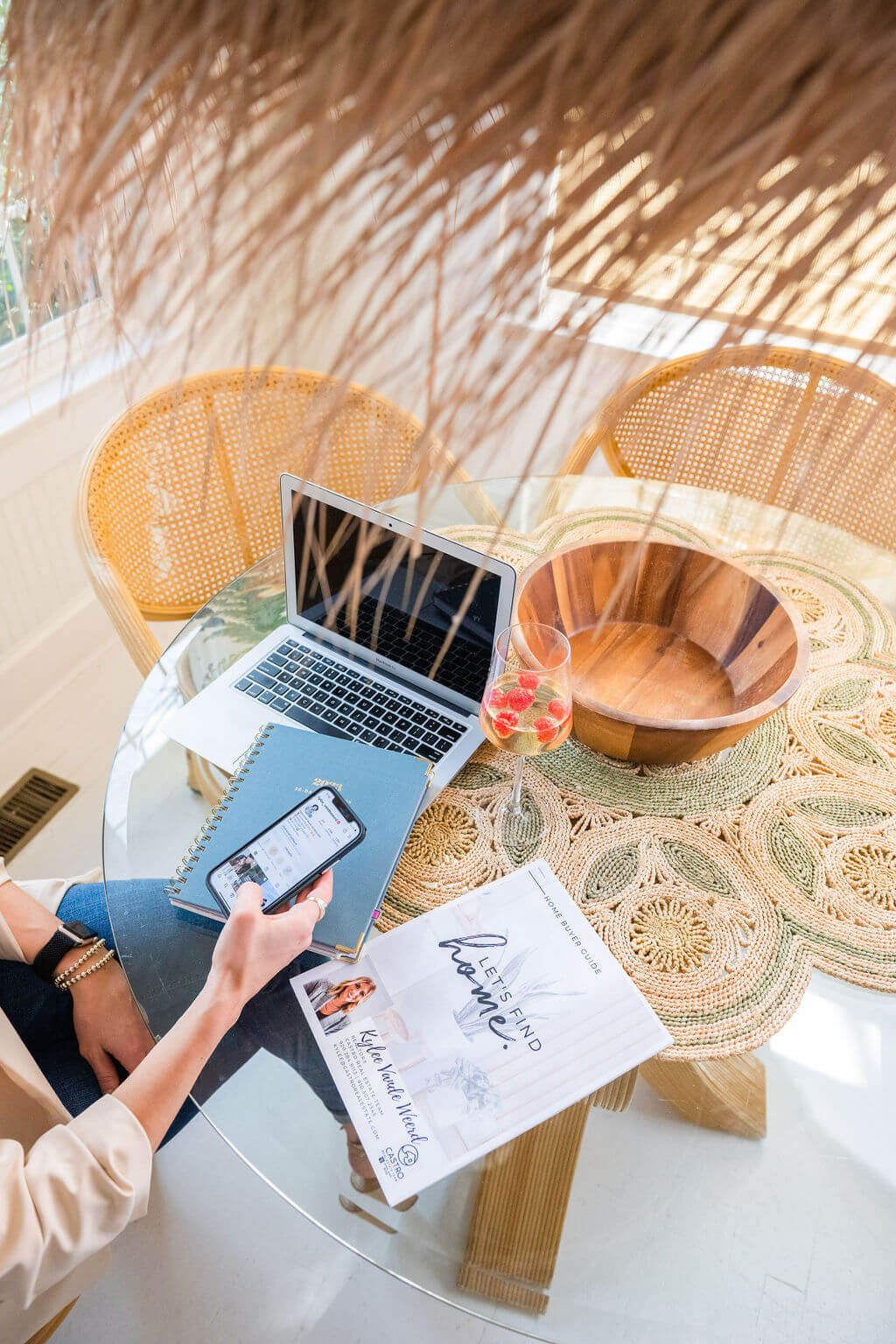 laptop and marketing materials spread out on boho table in Wilmington, North Carolina