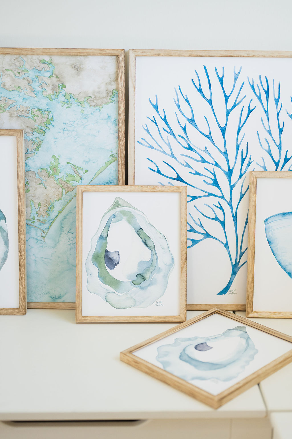 coastal watercolor artwork displayed in wooden frames in Wilmington, North Carolina