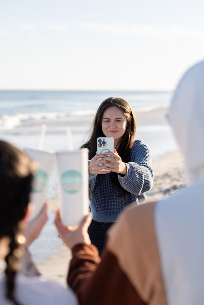 Meet Annie, a content queen with drive and spunk taking a branding photo at the beach in Wilmington, NC