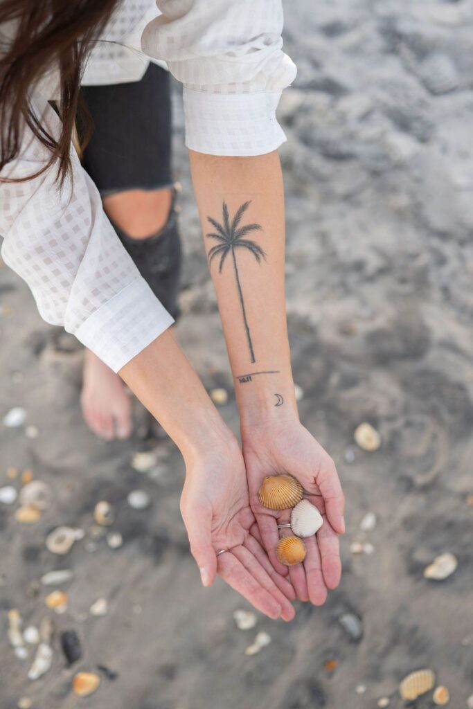 Meet Annie, a content queen with drive and spunk holding sea shells at the beach in Wilmington, NC