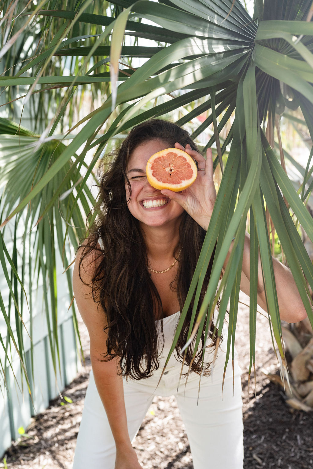 Mind Block Media owner, Annie, cheesing with a grapefruit depicting her authentic self