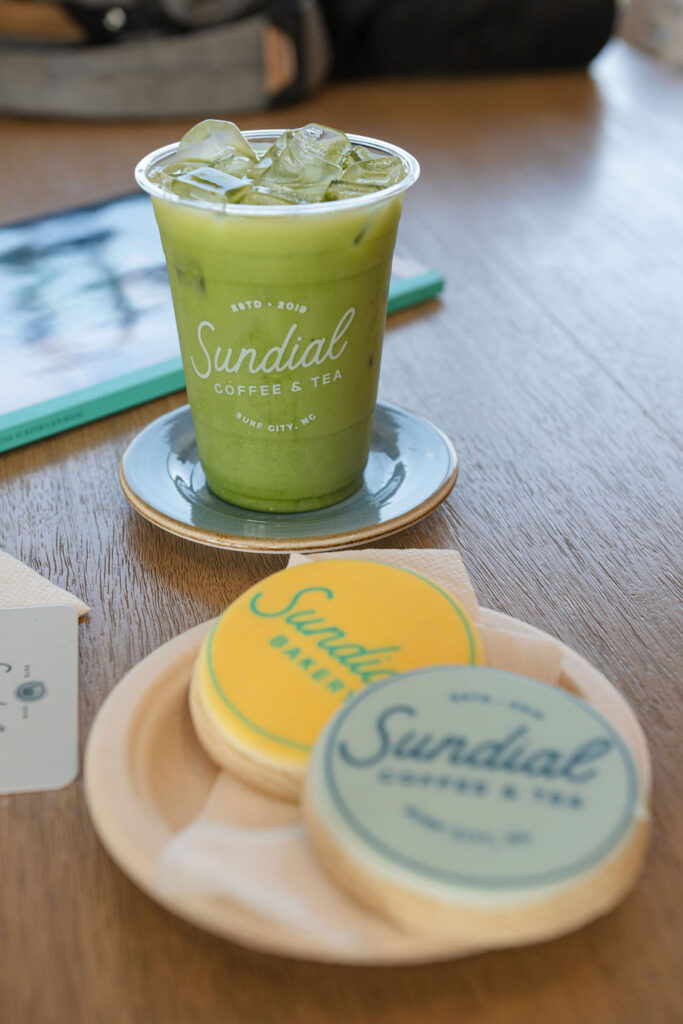 green tea matcha on brown table with logo sugar cookies in yellow and teal