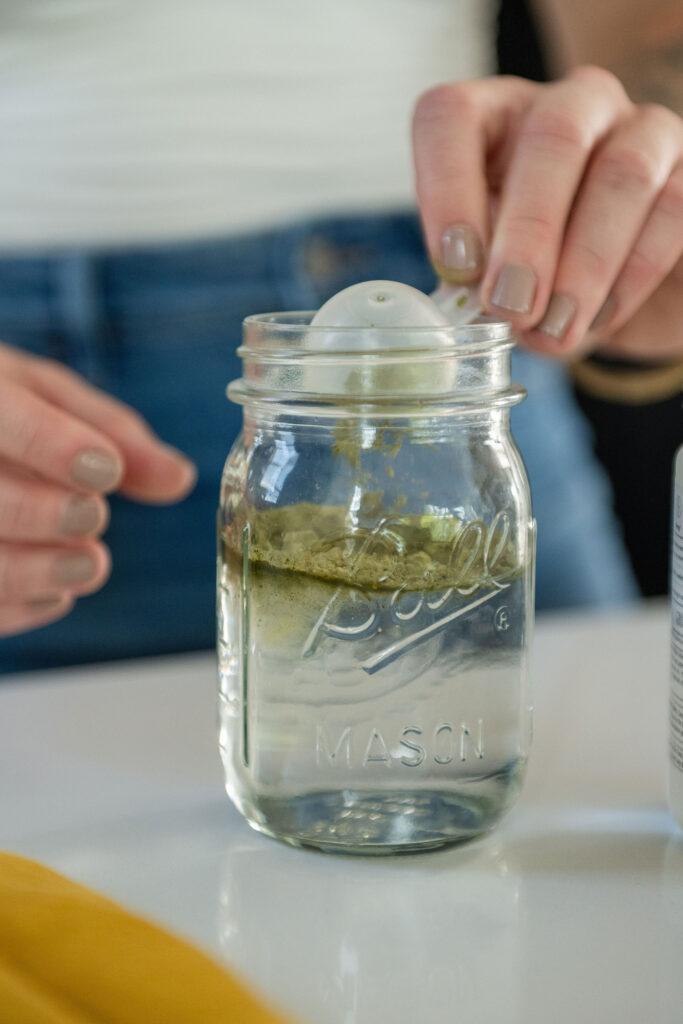 A branding photoshoot in a modern, moody kitchen for a female fitness and health coach.