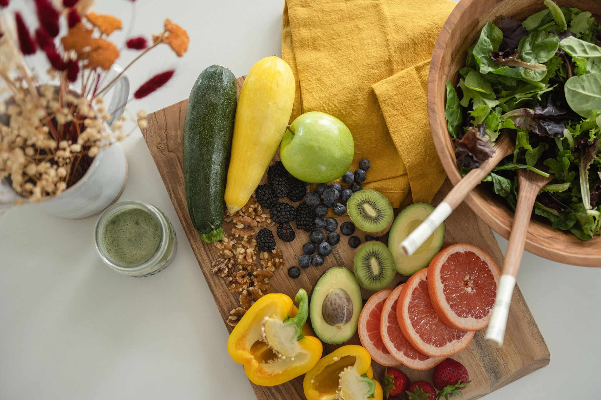 A branding photoshoot in a modern, moody kitchen for a female fitness and health coach.