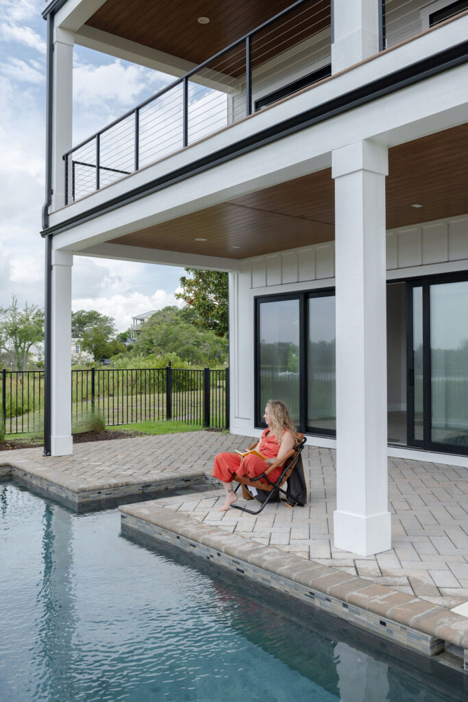 A branding photoshoot for a female fitness and health coach sitting by the pool.